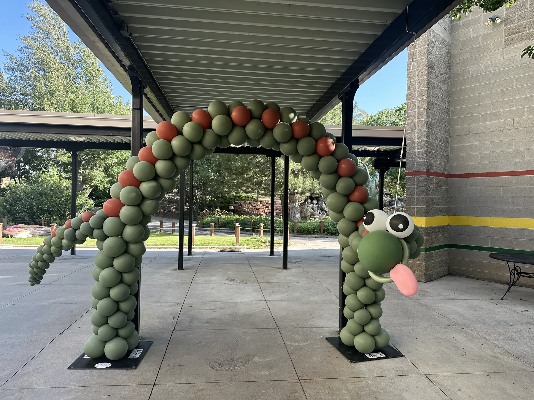 Dinosaur-themed balloon arch installation